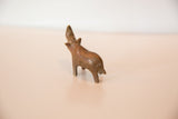 Vintage copper rhino figurine from a high rear angle showing its raised head.
