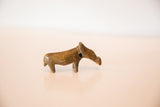 Vintage African bronze hippo figurine showing its slender profile and aged patina.