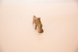Frontal view highlighting the textured bronze and handmade details of a hippo figurine.