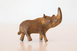 Textured bronze rhino sculpture head, featuring the prominent horn and rich patina.