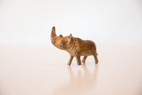 Angled close-up of the vintage bronze rhinoceros head, showing time-softened textured patina.