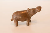 Profile of a vintage African copper hippo with a charming handmade texture.