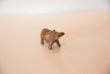 The simple, handmade form of a vintage copper hippo sculpture from a side angle.