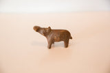 Vintage copper hippo sculpture looking up, showing its handmade details and aged patina.