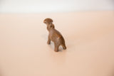 Rear angle of a handmade copper hippo showing its stout body and tail.