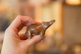 Side profile of a vintage handmade copper hippo showing its warm, aged patina.