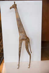 Side profile of a vintage bronze giraffe showing its aged, textured patina.