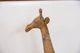 Detailed profile of the vintage bronze giraffe head highlighting its textured, aged patina.