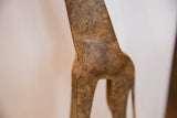 Aged bronze patina over the etched repeating pattern of the vintage giraffe sculpture.