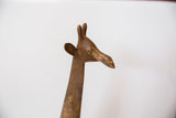 Profile view of the vintage bronze giraffe's head showing its rustic, aged patina.
