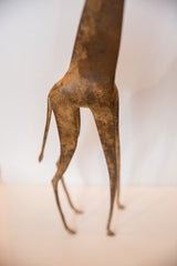 Close view of the vintage bronze giraffe's hindquarters showing its textured print.