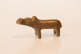 The simple, solid form of a miniature copper hippo with an aged, textural patina.