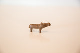 Simple cast form and aged texture of a vintage miniature copper hippo.