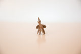 Rear view of a vintage copper elephant showing its small tail and ears.