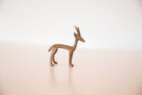 Side profile of the vintage African copper gazelle showing its slender handmade form.