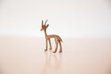 Rear view of the vintage copper gazelle highlighting its slender legs and dusty, textured patina.