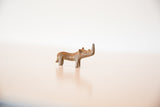 Small vintage African rhino sculpture showing its overall form and scale.