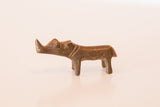 Side view of a vintage African copper rhino showing its handcrafted charm.