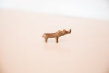 Side view of the vintage cast copper rhino highlighting its handmade form and aged patina.