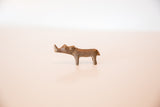 Full profile view of a vintage handmade African copper rhino sculpture.