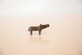 Side view of a small vintage copper hippo sculpture showing its handmade texture.