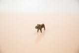 Straight-on view of the vintage dark copper hippo's charming, simple form.