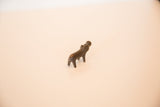 Vintage copper hippo figurine viewed from a high angle, showing its dark patina.