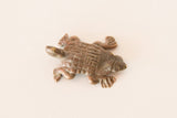 Vintage African copper turtle charm showing its textured, cast shell and time-softened patina.