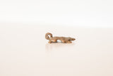 Side profile of the vintage cast copper turtle charm showing its textured form.