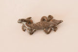 Cast copper African lizard charm showing its rustic texture and dark patina.