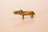 The handcrafted form of a miniature African bronze hippo with a warm golden patina.