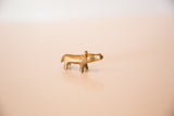 Profile view of the small African bronze hippo showing its handmade form and golden patina.