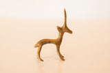 Profile view of a vintage bronze gazelle highlighting its handmade texture and patina.