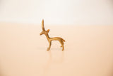 Aged patina on the slender profile of a vintage bronze gazelle figurine.