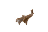 Vintage African bronze elephant figurine with a rustic patina and its trunk raised.