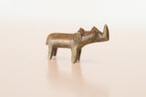 Side view of the vintage African bronze rhino highlighting its aged, handmade finish.