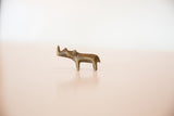 Side view of a small handmade African rhino sculpture in dark bronze.