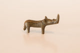 Side view of the miniature curved bronze rhino featuring aged, textured patina.