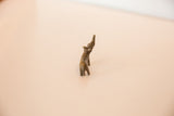 Handmade vintage bronze rhinoceros with a distinctive curved back and rich patina.