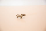 The simple, handcrafted form of a tiny vintage bronze hippo sculpture.