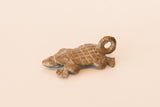 Vintage African bronze turtle pendant with a textured shell and dusty patina.
