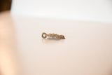 African bronze turtle pendant side profile with dusty patina, showing textured surface.