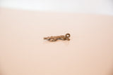 Vintage African bronze lizard pendant with a textured surface and dusty, aged patina.