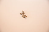 Oblique view of the vintage bronze lizard pendant highlighting its handmade form and texture.