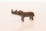 Side profile view of a vintage dark bronze rhino sculpture with a textured finish.