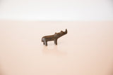 Vintage African bronze rhino figurine shown in profile with a dark, aged patina.