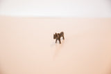High-angle view of the small, collectible African bronze rhino figurine.