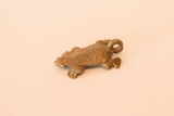 Side view of the vintage bronze turtle pendant showing its textured shell and shape.