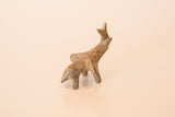 Rear angle of a vintage bronze elephant showing its hand-cast form and dusty patina.
