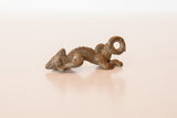Side view of the vintage chameleon pendant showing the textured casting and aged bronze patina.